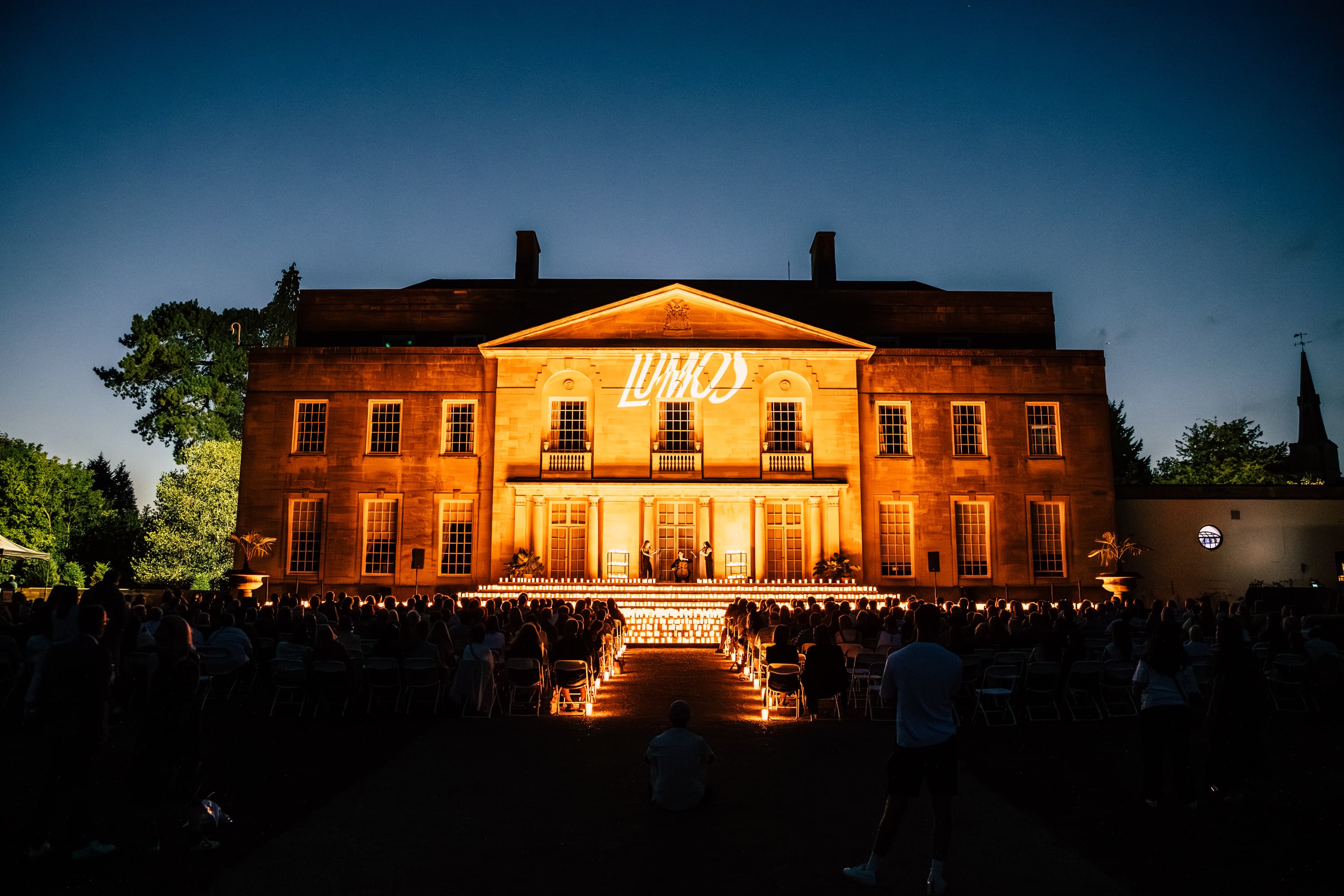Historic manor lit at dusk